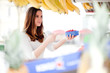 Young woman buying raspberries at the market
