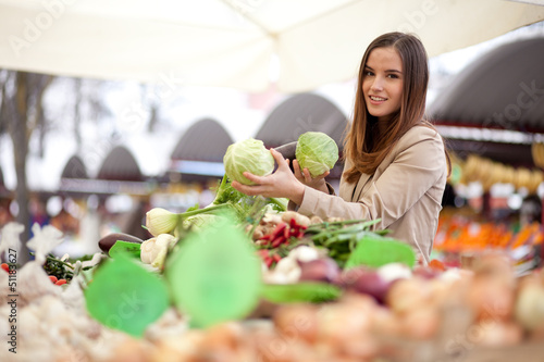 Photo: Woman buying vegetables at the market Woman buying vegetables at the market