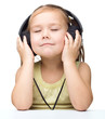 Little girl is enjoying music using headphones