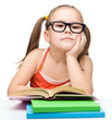 Little girl is reading a book