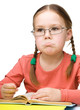 Little girl is reading a book