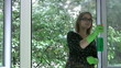 Girl washing window and shows tongue