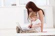 Happy young mother and her  daughter using a laptop