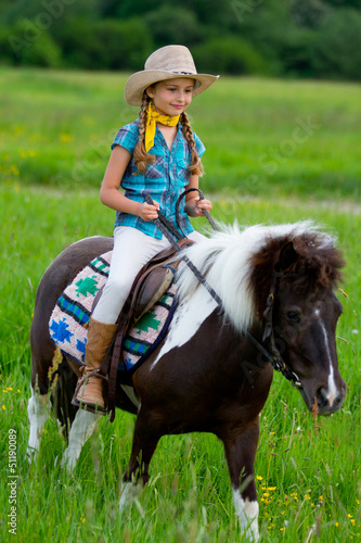 Photo: Ranch, horse riding - portrait of lovely girl on a pony Ranch, horse riding - portrait of lovely girl on a pony