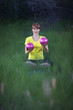 woman  in yoga position, raising   silver fitness balls