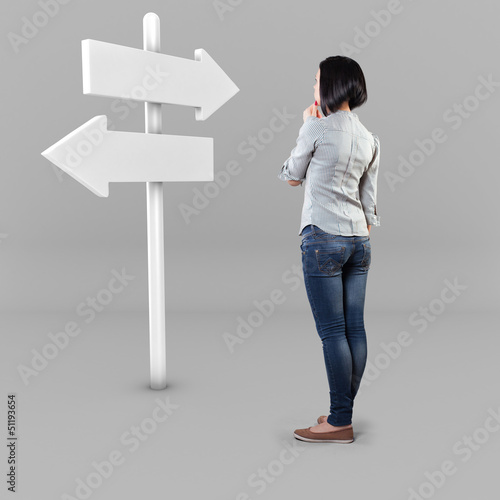 Photo: Girl before a roadsign Girl before a roadsign