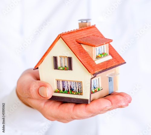 Photo: house in human hands house in human hands