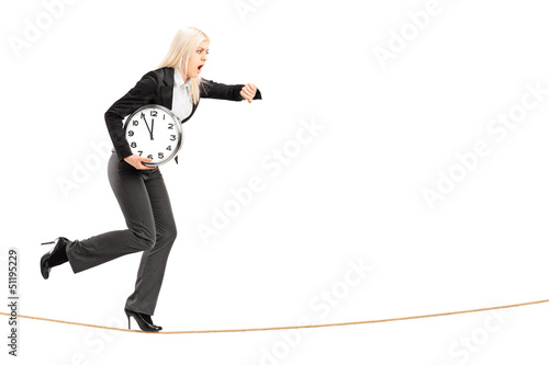 Photo: Full length portrait of a young businesswoman running late on a Full length portrait of a young businesswoman running late on a