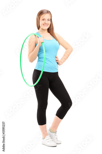 Photo: Full length potrait of a young female athlete holding a hula-hoo Full length potrait of a young female athlete holding a hula-hoo