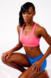 Photo: Pretty black woman kneeling on floor with a determined look Pretty black woman kneeling on floor with a determined look