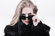snobbish upper class girl in dark sunglasses and fur