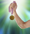 hand and gold medal