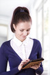 Student girl reading electronic books on an e-reader