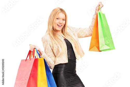 Photo: A beautiful young woman holding shopping bags A beautiful young woman holding shopping bags