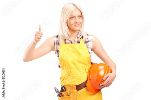 Photo: A female construction worker with equipment giving thumb up A female construction worker with equipment giving thumb up