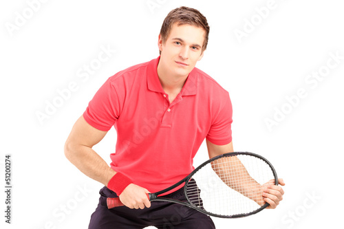 Photo: A male tennis player holding a racket A male tennis player holding a racket