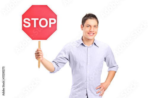 Photo: A man holding a traffic sign stop A man holding a traffic sign stop