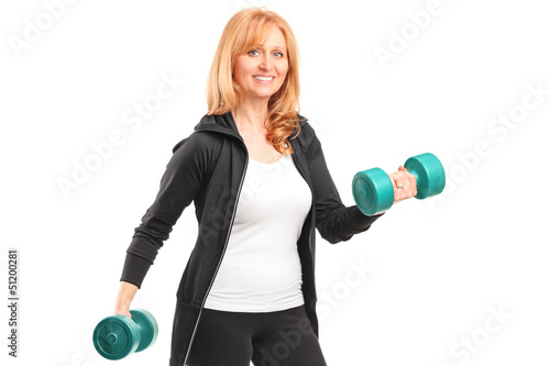 Photo: A mature woman lifting up dumbbells A mature woman lifting up dumbbells