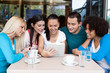 teens using their digital tablet in a cafe