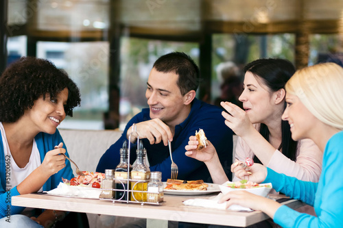 Photo: Cheerful friends chatting while lunch Cheerful friends chatting while lunch