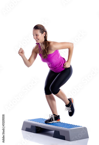 Photo: Woman doing step exercise Woman doing step exercise