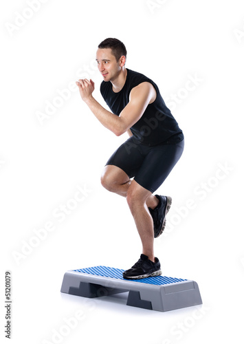 Photo: young male doing step exercise young male doing step exercise