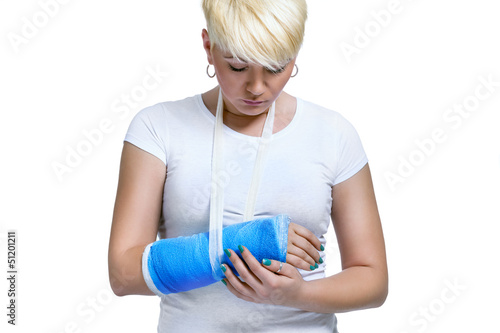 Photo: woman holding painful broken arm woman holding painful broken arm