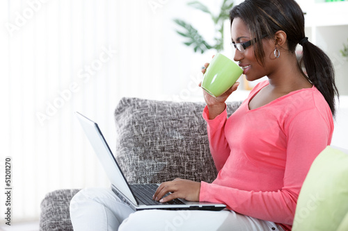 Photo: Woman in a sofa with laptop Woman in a sofa with laptop