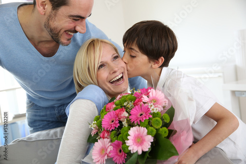 Photo: Young boy with father celebrating mother's day Young boy with father celebrating mother's day