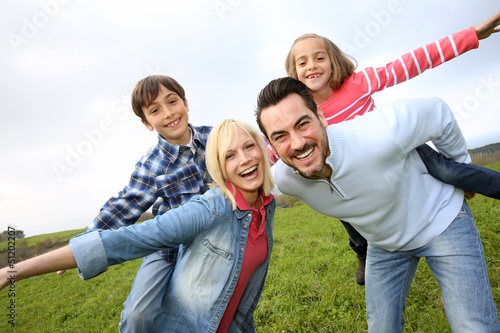 Photo: Portrait of happy family in countryside Portrait of happy family in countryside