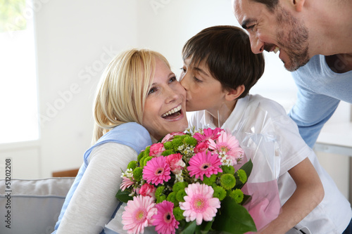 Photo: Young boy with father celebrating mother's day Young boy with father celebrating mother's day