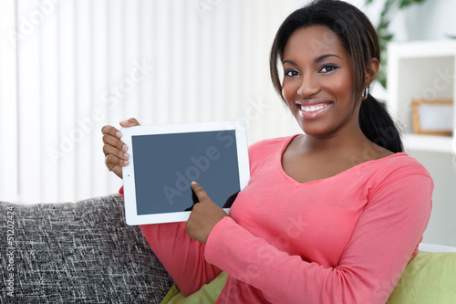 Photo: Woman pointing at empty tablet screen Woman pointing at empty tablet screen
