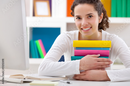 Photo: cheerful girl hugging books cheerful girl hugging books