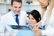 Photo: dentist showing a patient her teeth x-ray dentist showing a patient her teeth x-ray
