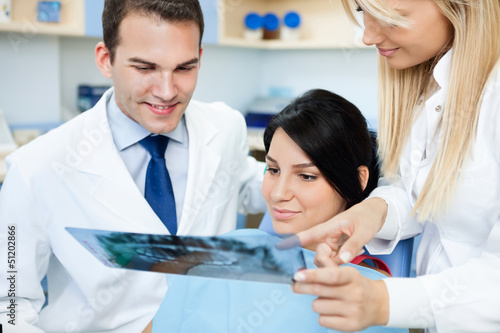 Photo: dentist showing a patient her teeth x-ray dentist showing a patient her teeth x-ray
