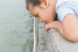 A cute girl is staring to the sea