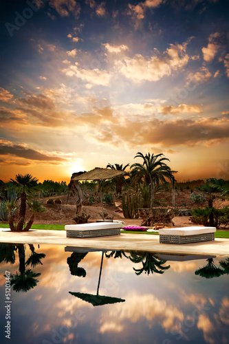 Photo: Beach beds with next at pool. Beach beds with next at pool.