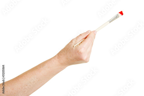 Photo: Hand malt mit Pinsel die Farbe rot Hand malt mit Pinsel die Farbe rot