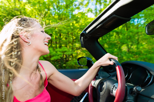 Photo: Young woman with cabriolet in summer on day trip Young woman with cabriolet in summer on day trip
