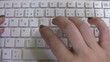 Hand typing on keyboard time lapse
