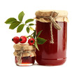 jars with hip roses jam and ripe berries, isolated on white