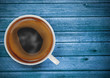 cup of coffee on blue wooden table