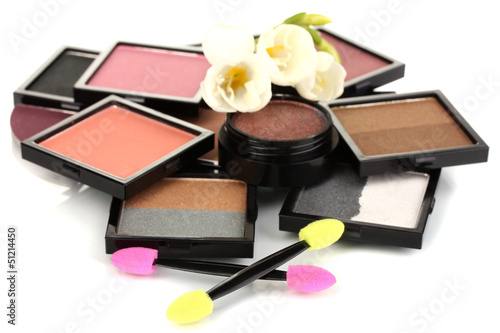 Photo: Bright eye shadows and sponge brushes for foundation isolated Bright eye shadows and sponge brushes for foundation isolated