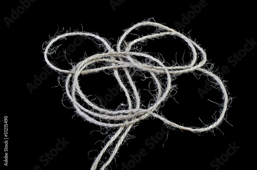 Photo: Tangled ball of twine isolated over black Tangled ball of twine isolated over black
