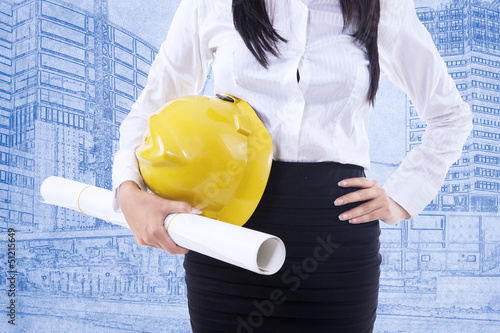Photo: Close-up safety helmet on blueprint Close-up safety helmet on blueprint