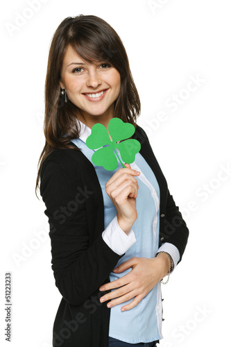 Photo: Smiling young woman holding shamrock leaf Smiling young woman holding shamrock leaf