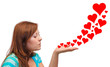 Young woman blowing hearts