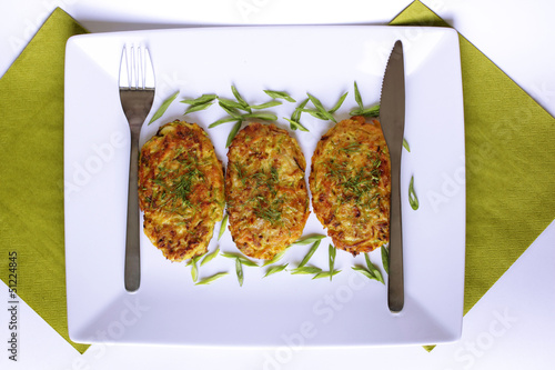 Photo: vegetarian vegetable pancakes on a white background vegetarian vegetable pancakes on a white background