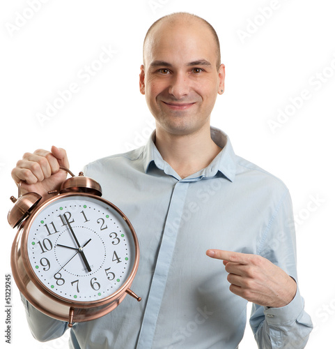 Photo: smiling guy pointing on a big alarm clock smiling guy pointing on a big alarm clock