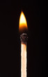 Burning match on a black background